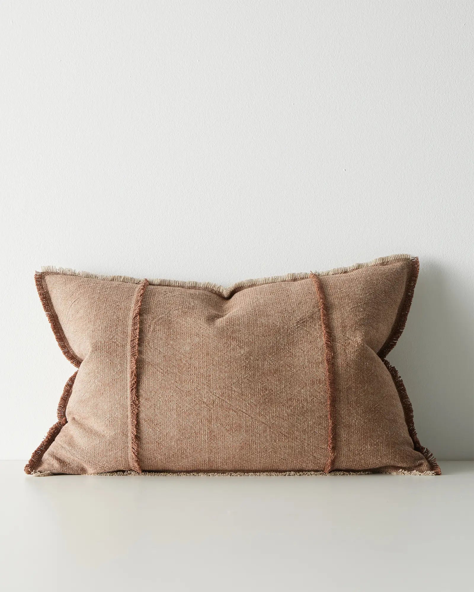 Brown pillow with frayed edges