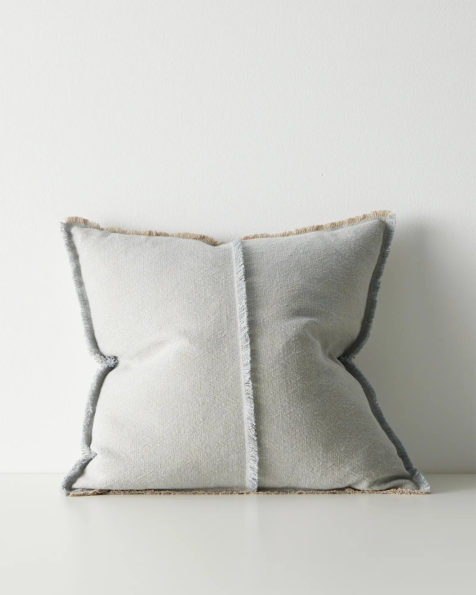 Gray pillow with textured trim.