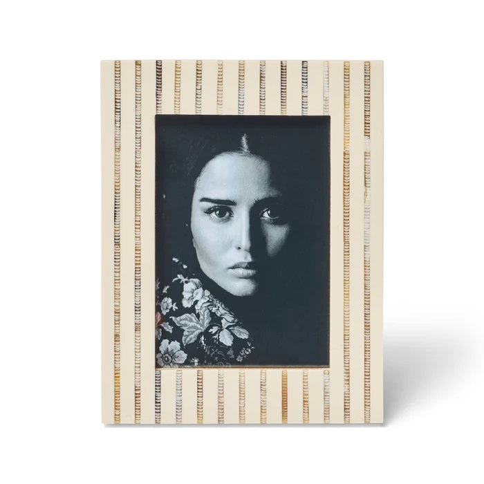 The Afia Photo Frame 5x7. This striking design is handcrafted from ivory coloured resin with hand-etched inlaid horn stripe.  
