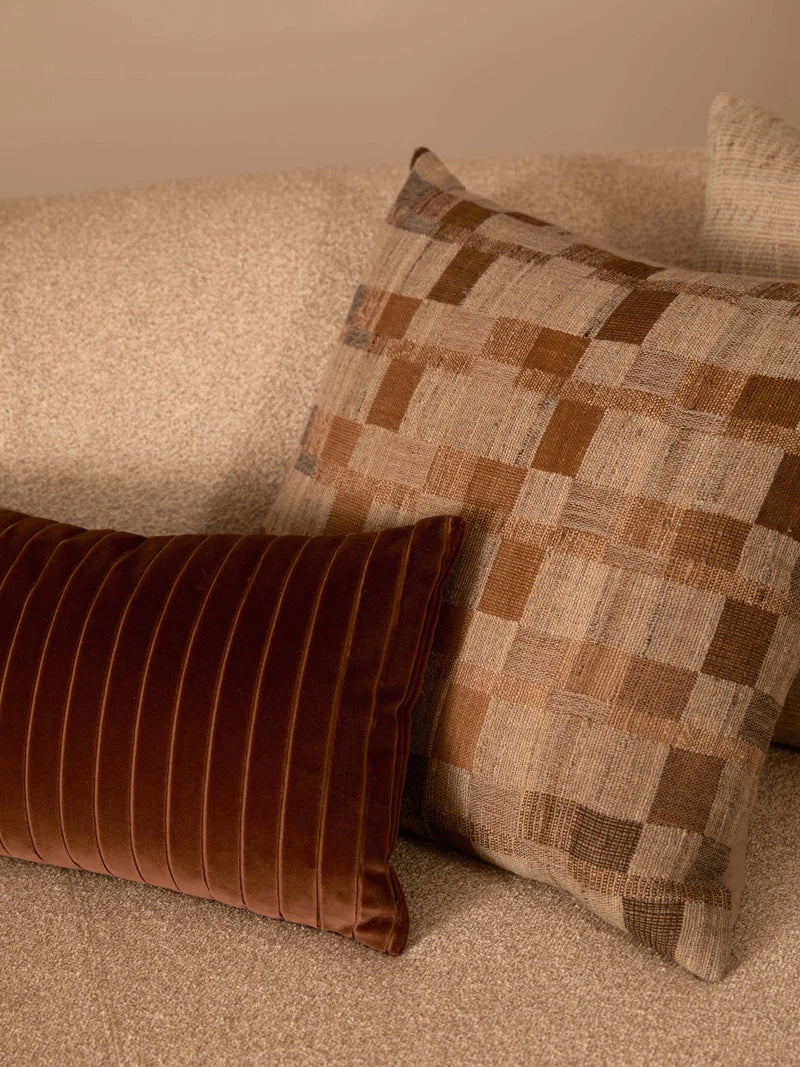 check patterned cushion in neutral tones.