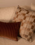 check patterned cushion in neutral tones.