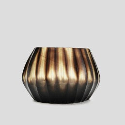 The Aura vase is mouth blown molten glass which is then hand carved to produce linear cuts making each piece totally unique.