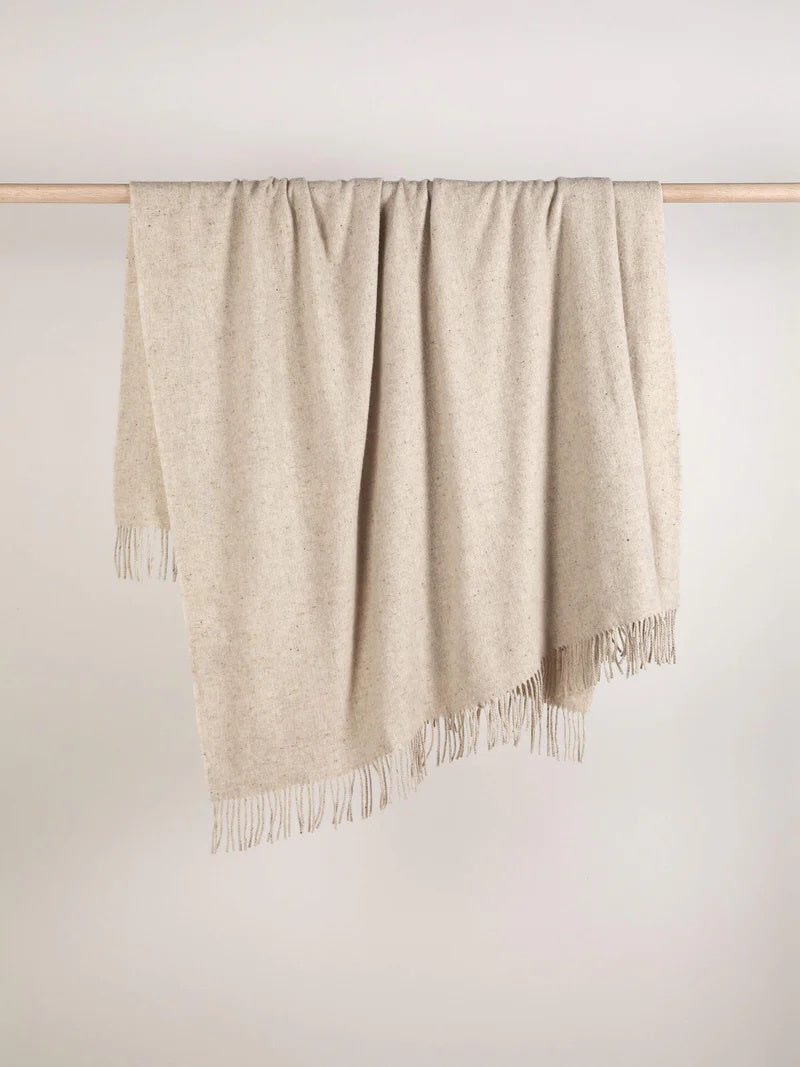 Beige throw blanket with fringes. Beige colour