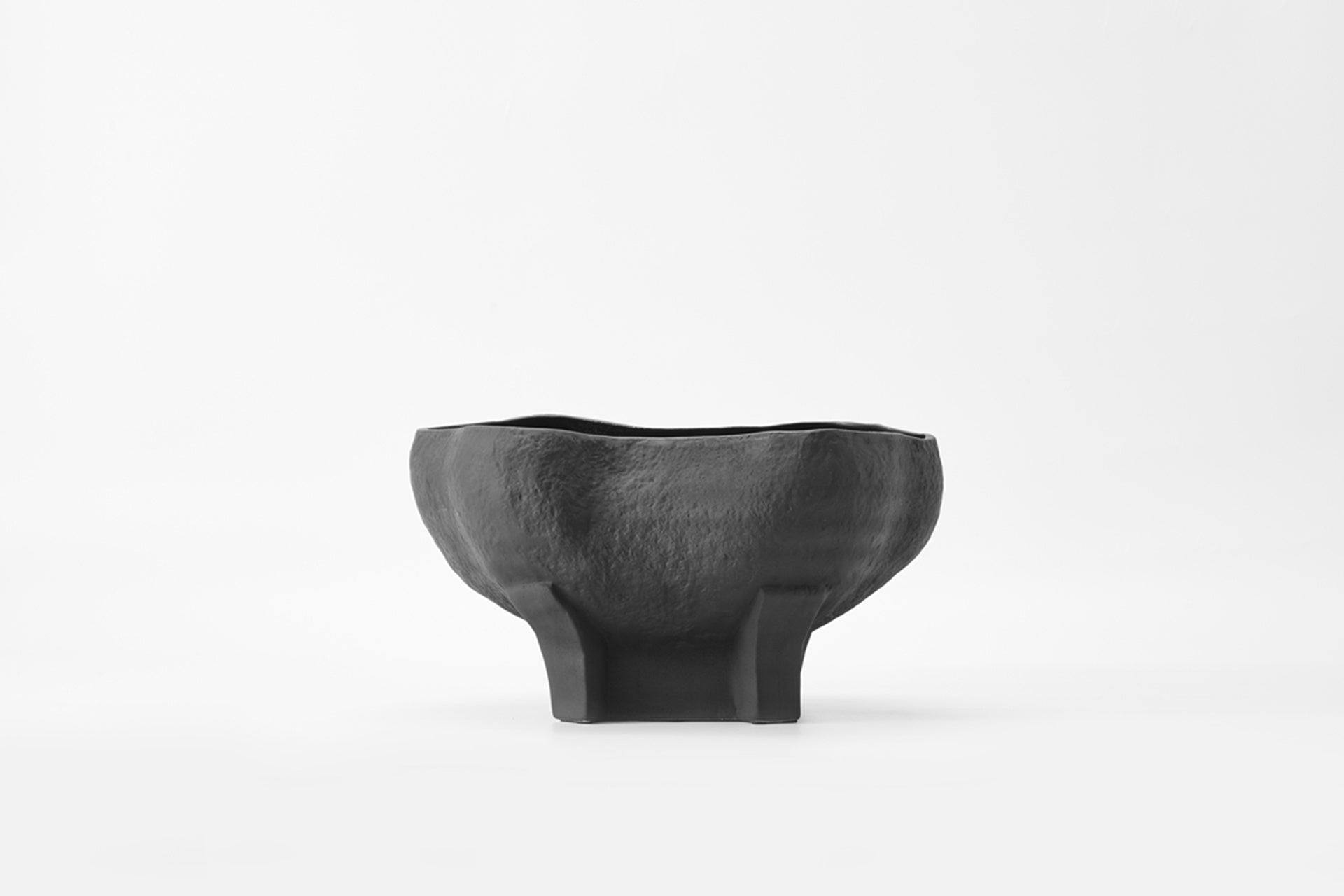 The Conch bowl is the perfect accent piece that showcases a refined organic form. Black and textured surace.