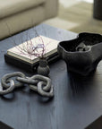 The Conch bowl is the perfect accent piece that showcases a refined organic form. Black and textured surface.