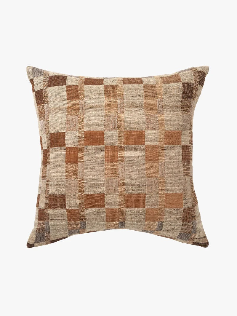 Checkered pillow with brown and beige pattern on a white background