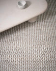 Textured neutral rug with a herringbone pattern
