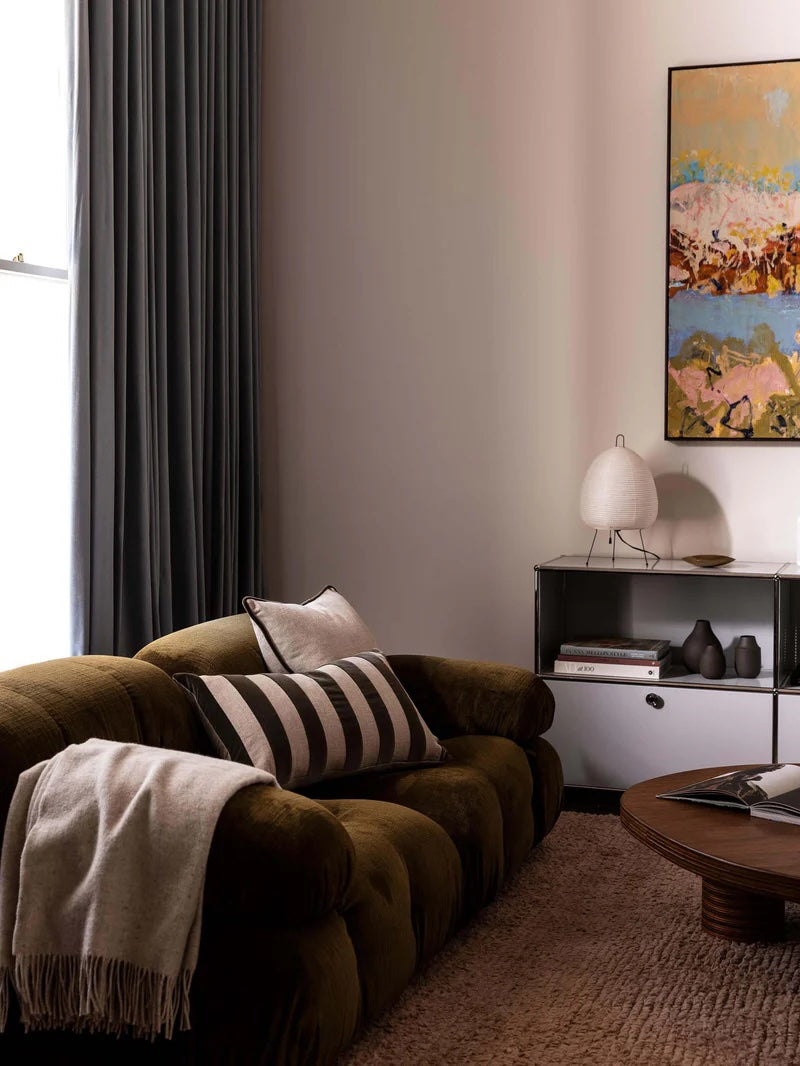 beige cushion with olive piped edge detail