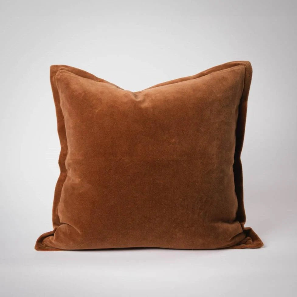 Meticulously crafted from the finest 100% short pile glossy cotton velvet and dyed to achieve a rich palette of exquisite hues with luxurious sheen. Each cushion is thoughtfully reimagined with a 1cm flange, offering a functional yet sophisticated option.  Colour Nutmeg. 50cm square