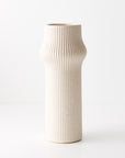 Gili is an ivory-coloured tall linear vase exudes understated elegance and modern simplicity. Its clean lines and neutral hue make it a versatile accent piece.