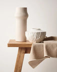 Gili is an ivory-coloured tall linear vase exudes understated elegance and modern simplicity. Its clean lines and neutral hue make it a versatile accent piece