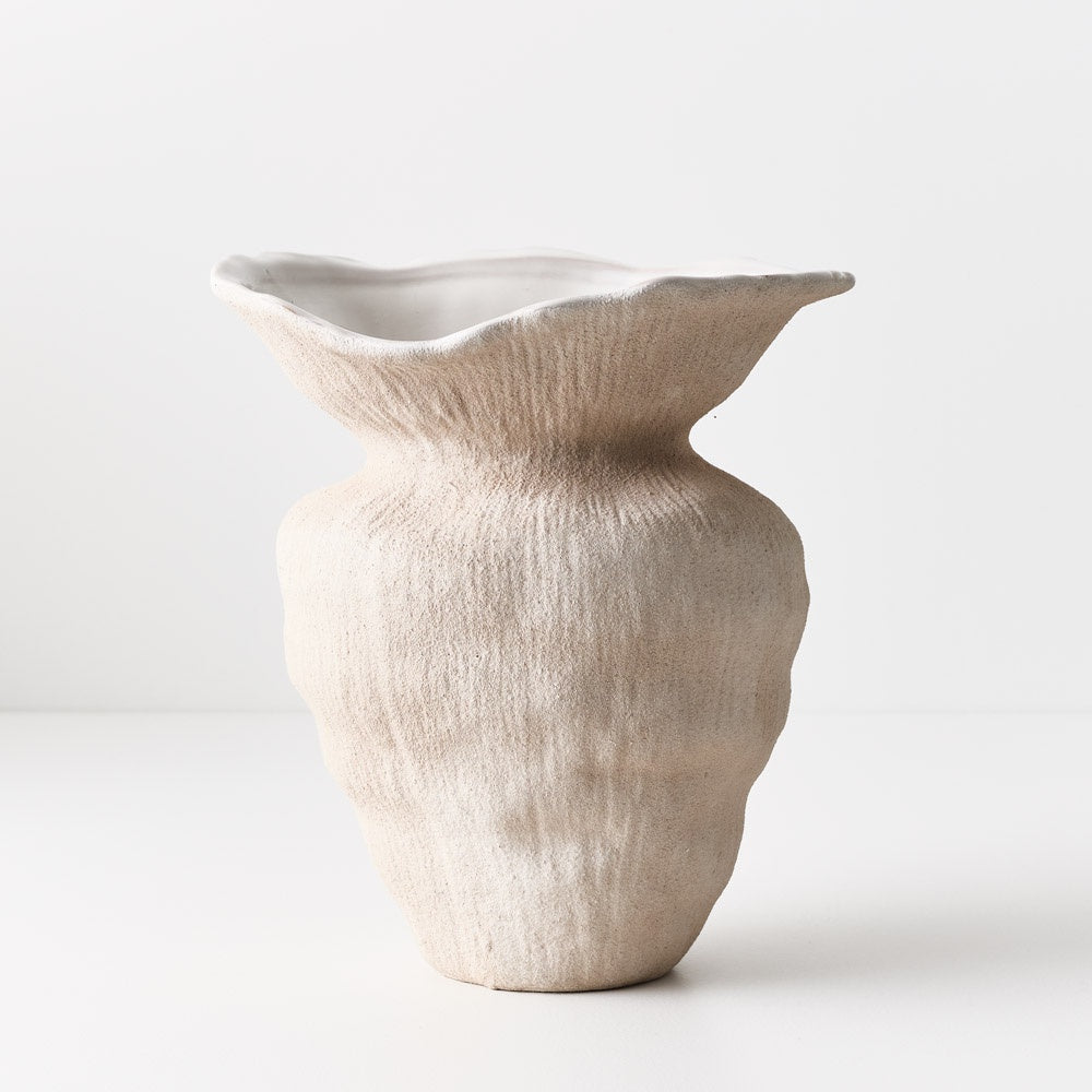 This ceramic pot starts with a common shape but is finished with an oversized collar, making it a standout talking piece. Its textured surface adds to its unique charm. Textured finish.Ivory colour.