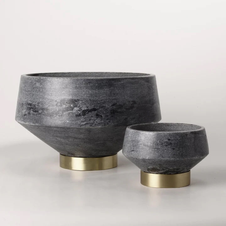 Beauty meets craftsmanship in this grey marble decorative bowl featuring a brass footed base.