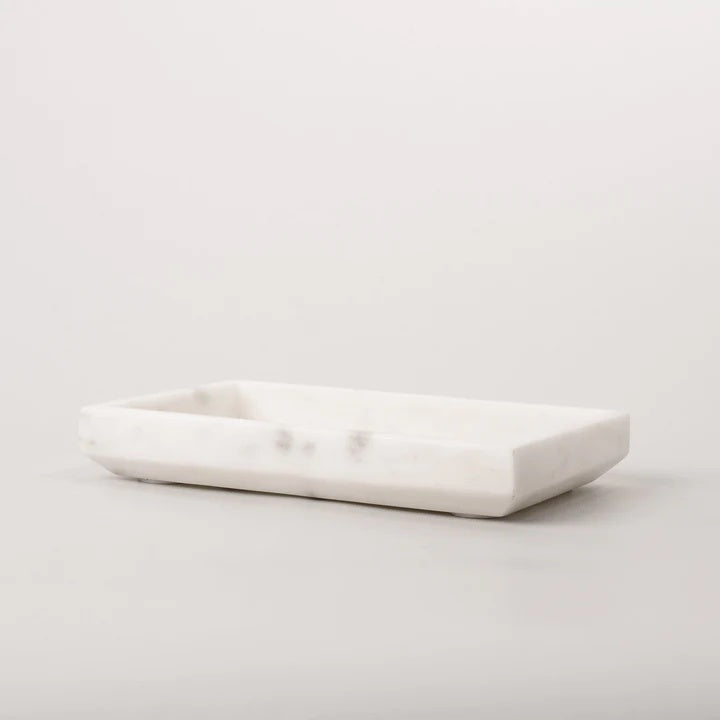 This white marble decorative taper tray effortlessly adapts to your styling needs. As the name suggests, the tapered edges create a unique profile.