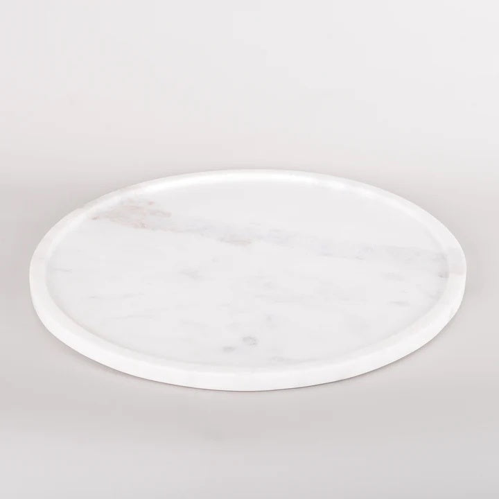 The shallow white marble round tray. is 30cm in diameter and made from beautiful marble with a shallow lip for a low profile.