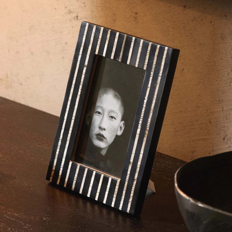 The Omari Photo Frame 4x6. This striking design is handcrafted from black resin with hand-etched inlaid horn stripe.