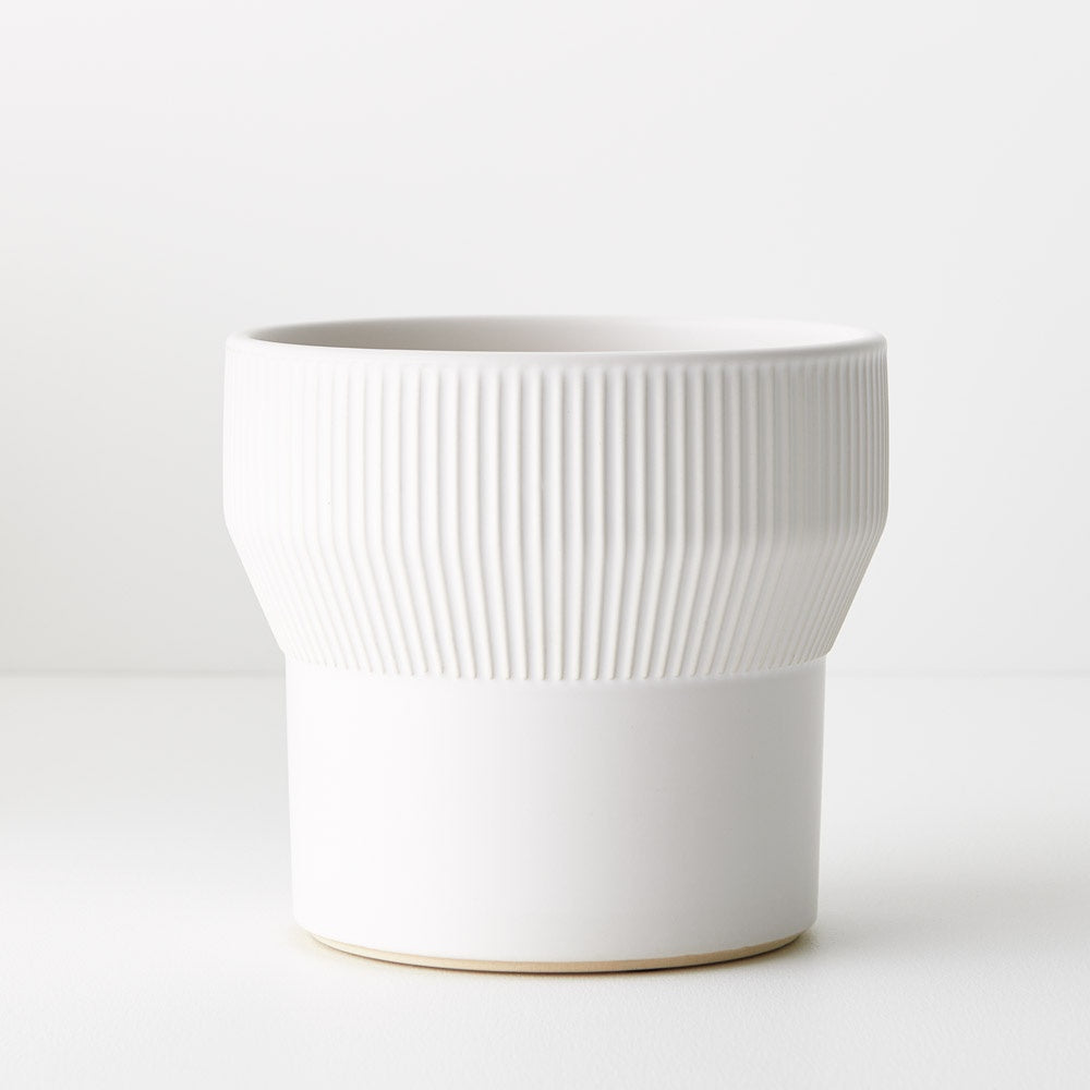 The 16cm Nalo Pot in grey boasts a chic ribbed detail at the top, adding texture and charm to any space. White colour