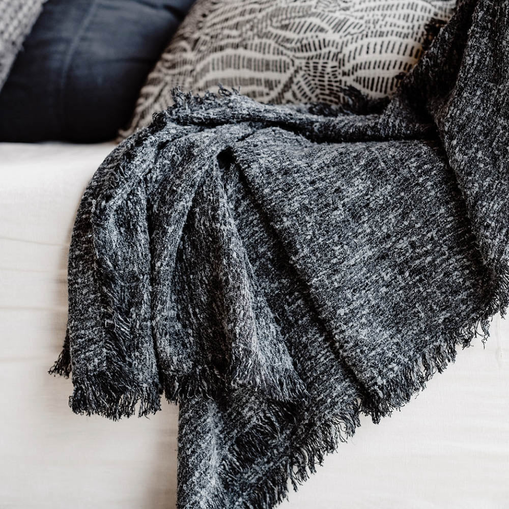 The Sora Throw, named after the Japanese word for "sky," captures the beauty of the midnight sky with a blend of deep blue tones and off-white yarns.
