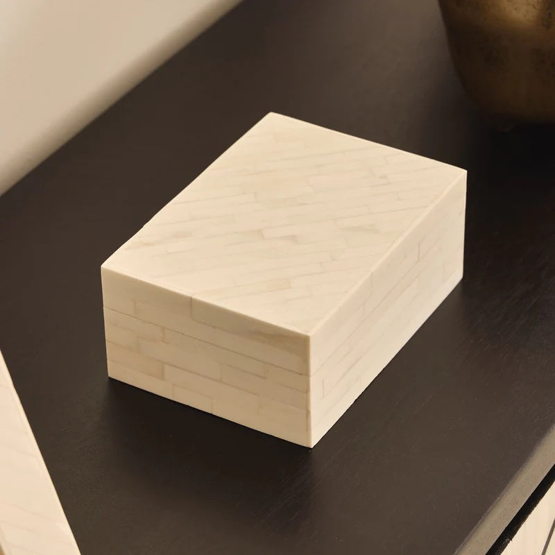 The Zorani Bone Box. This striking design is handcrafted from natural bone inlay. It effortlessly and neatly stows your precious and small items while lending a sophisticated, cultured look.