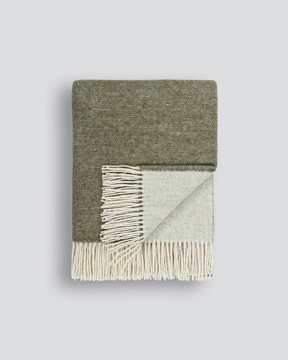 Olive green mottled blanket with white fringe