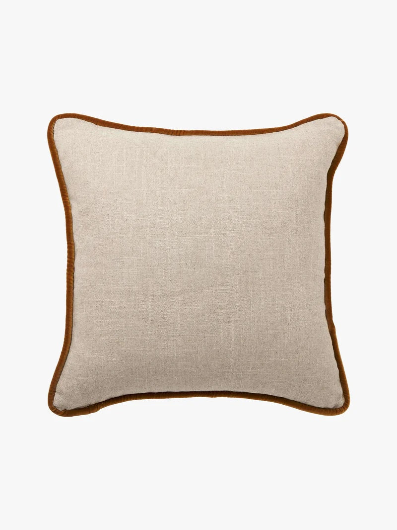 Beige pillow with toffee trim  edge detail.