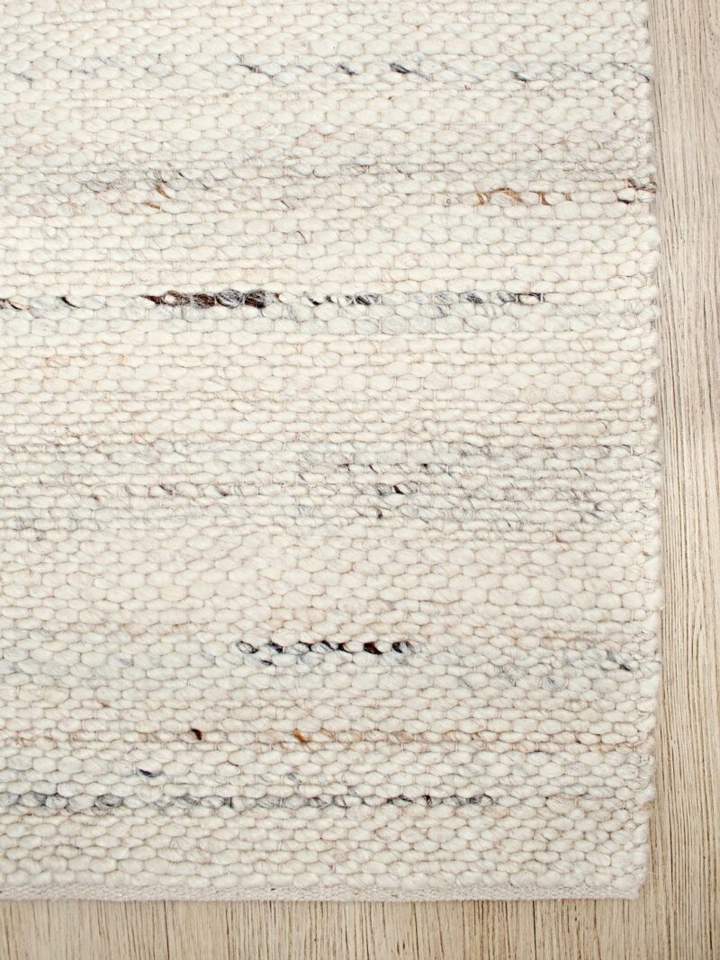 Textured area rug with a neutral color palette.