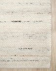 Textured area rug with a neutral color palette.