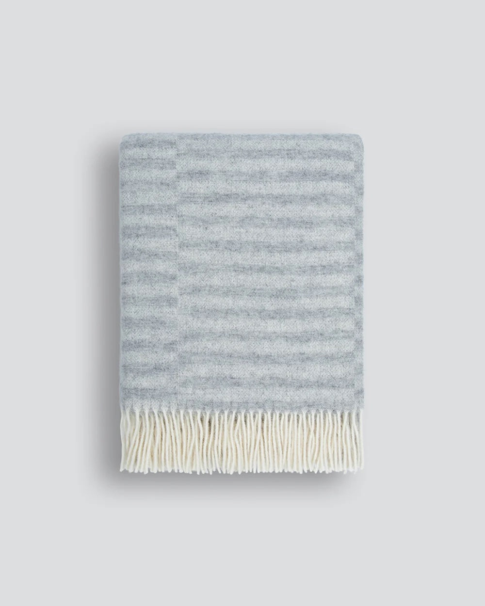 silver striped blanket with white fringing
