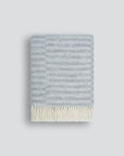 silver striped blanket with white fringing