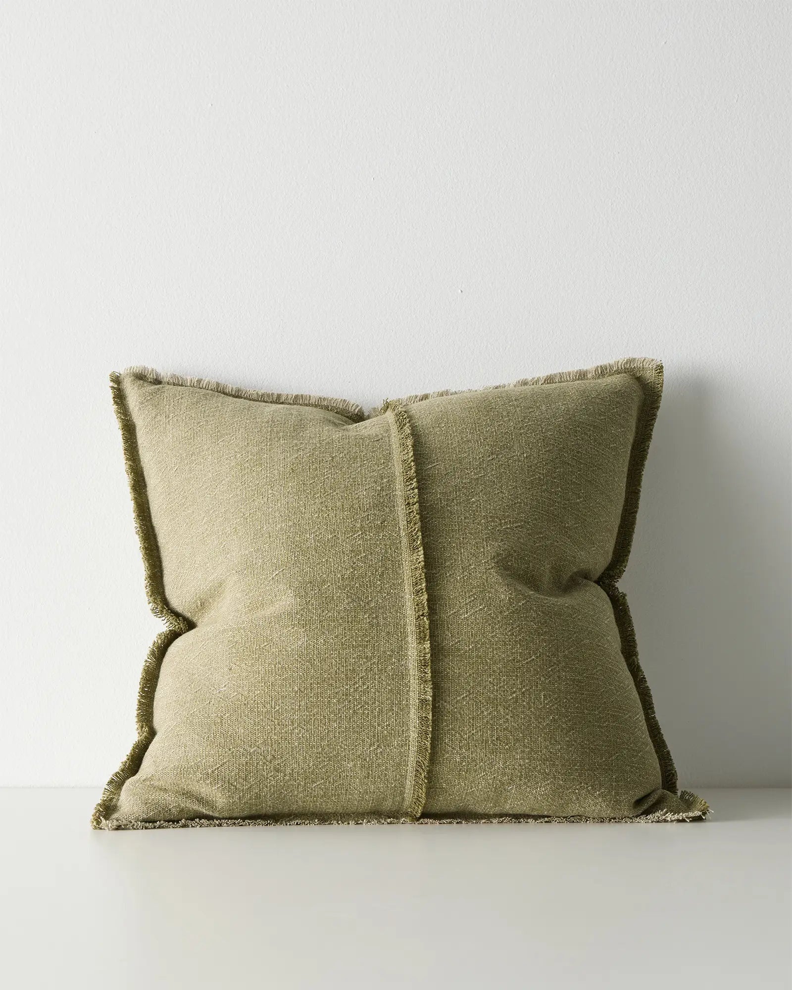 Green pillow with a textured  weave.