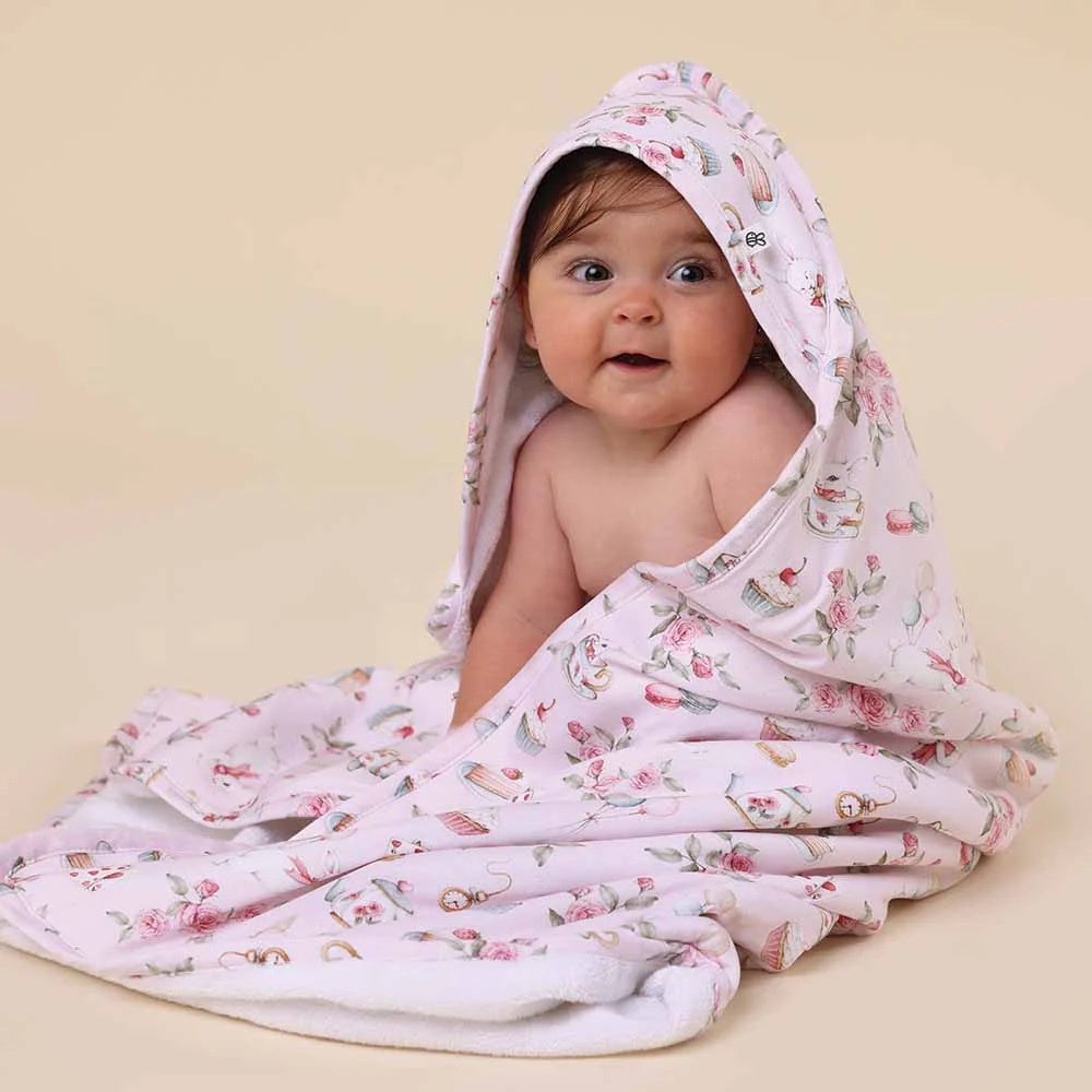 hooded towel featuring alice tea party print design on a pink background