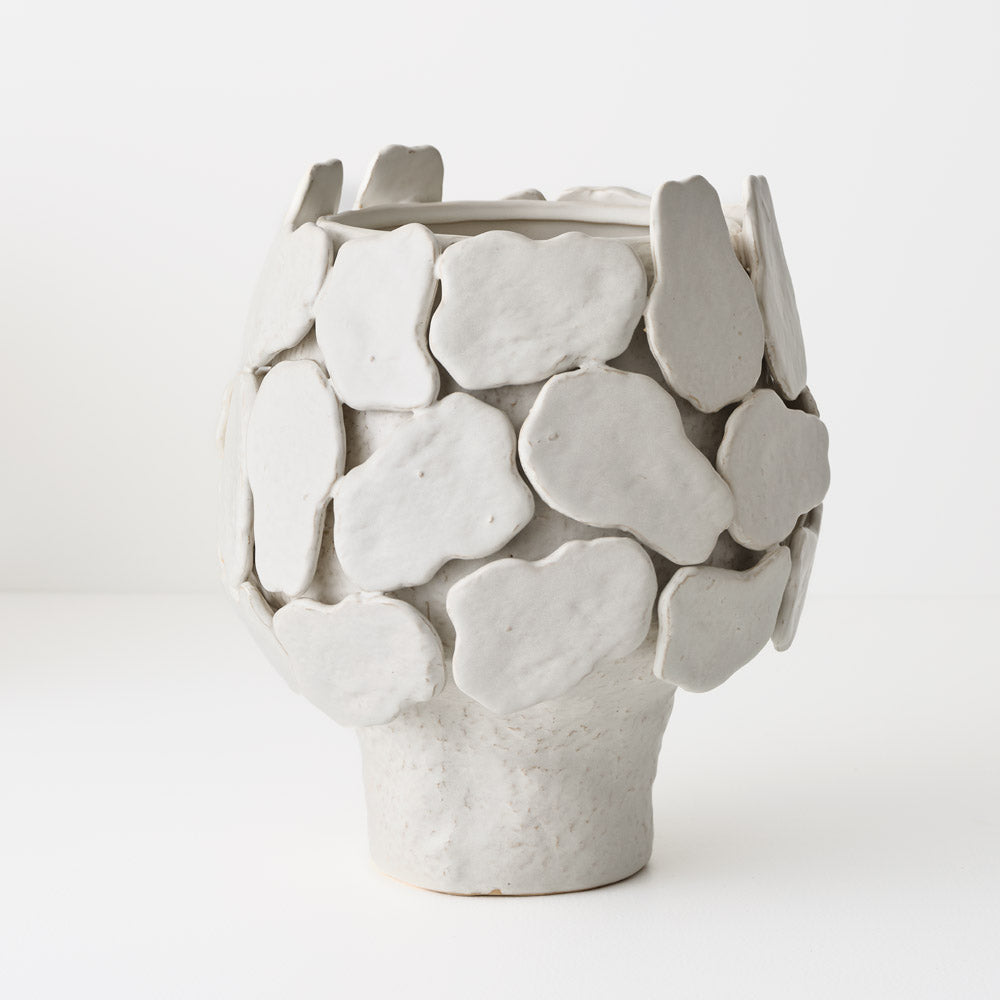 White ceramic vase with textured surface 
