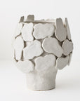 White ceramic vase with textured surface 