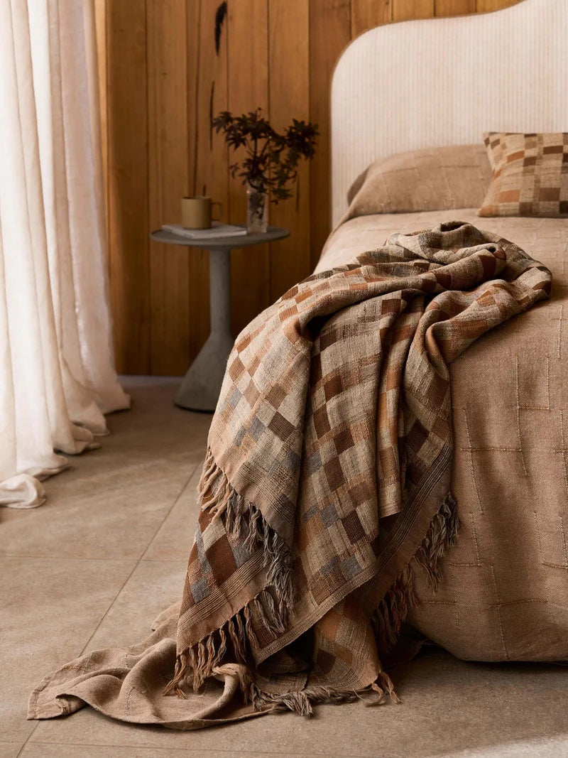 check pattern wool and silk throw in neutral beige tones.