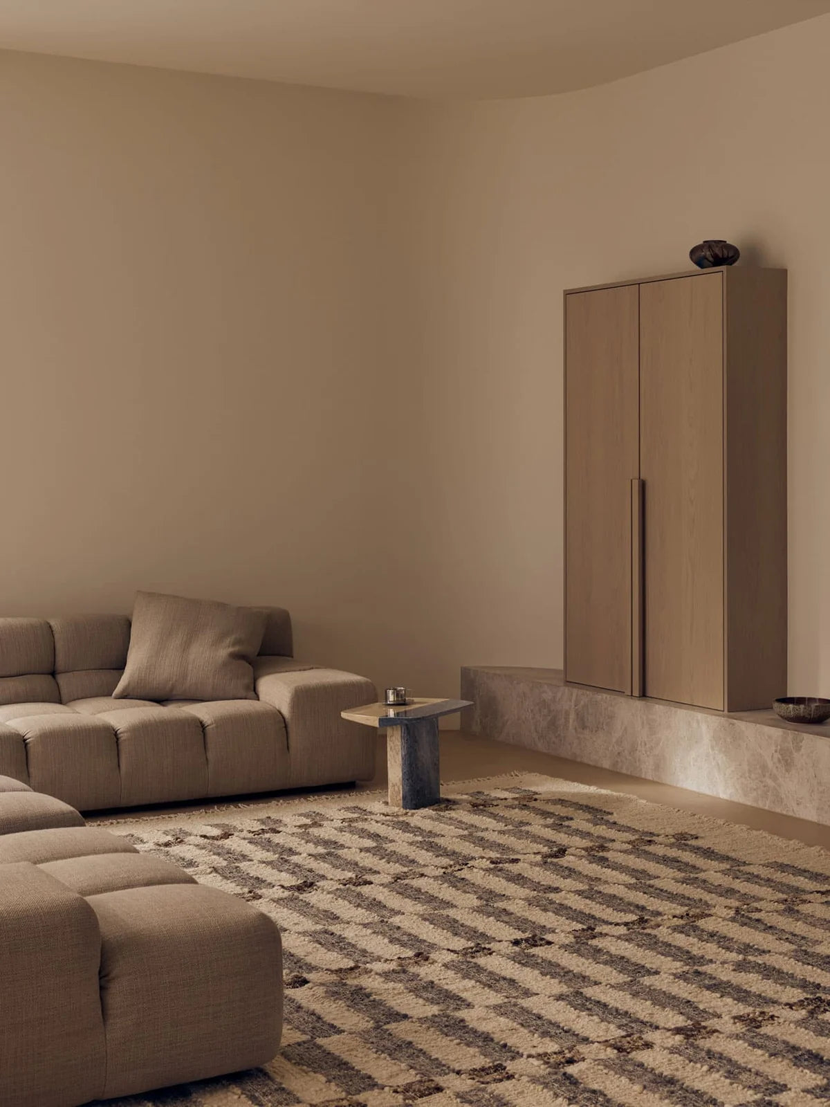 The tribe home Chet rug has a geometric grid pattern in earthy tones