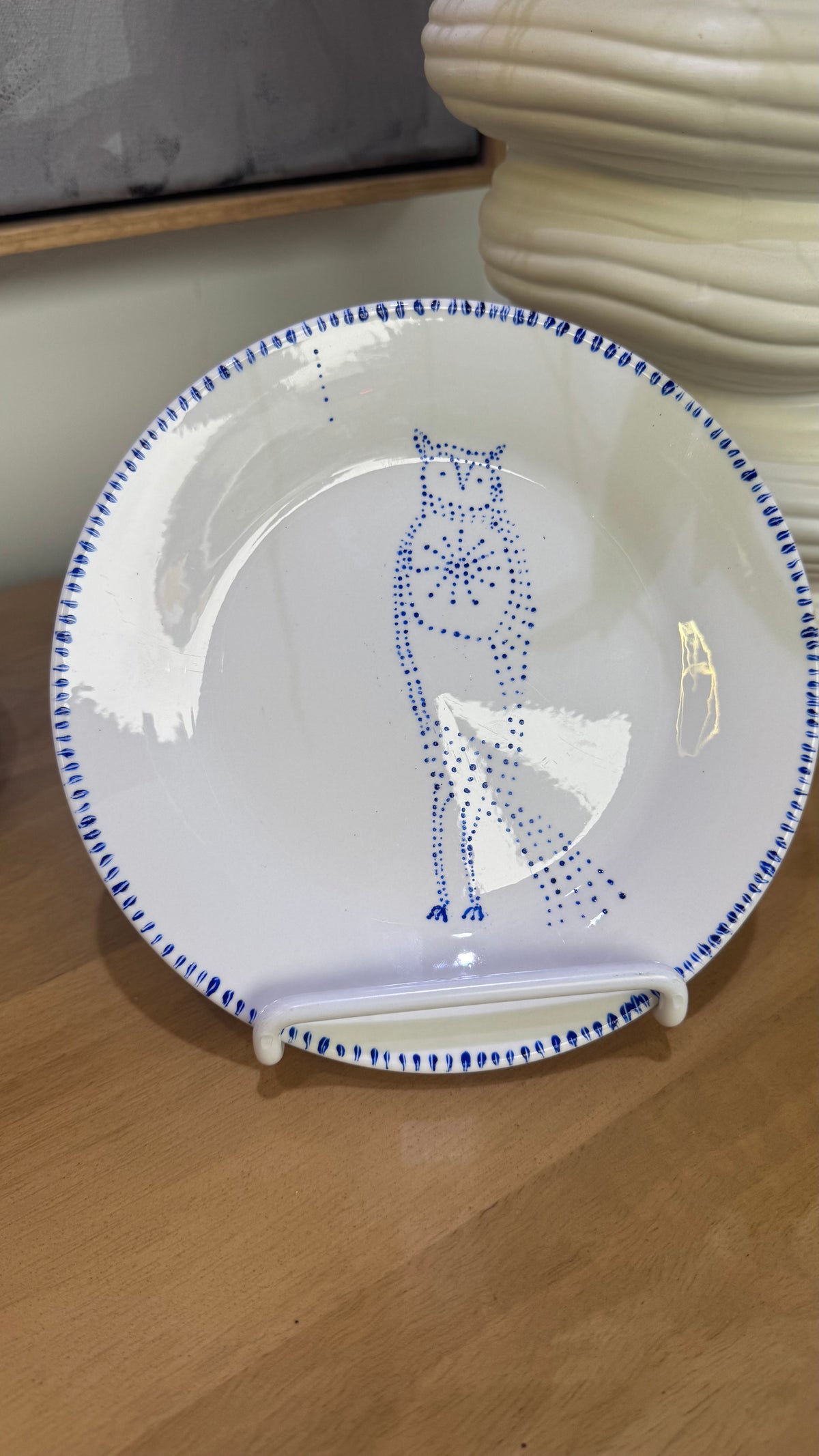 ceramic wall plate featuring blue cosmic owl by artist Nadia Robertson