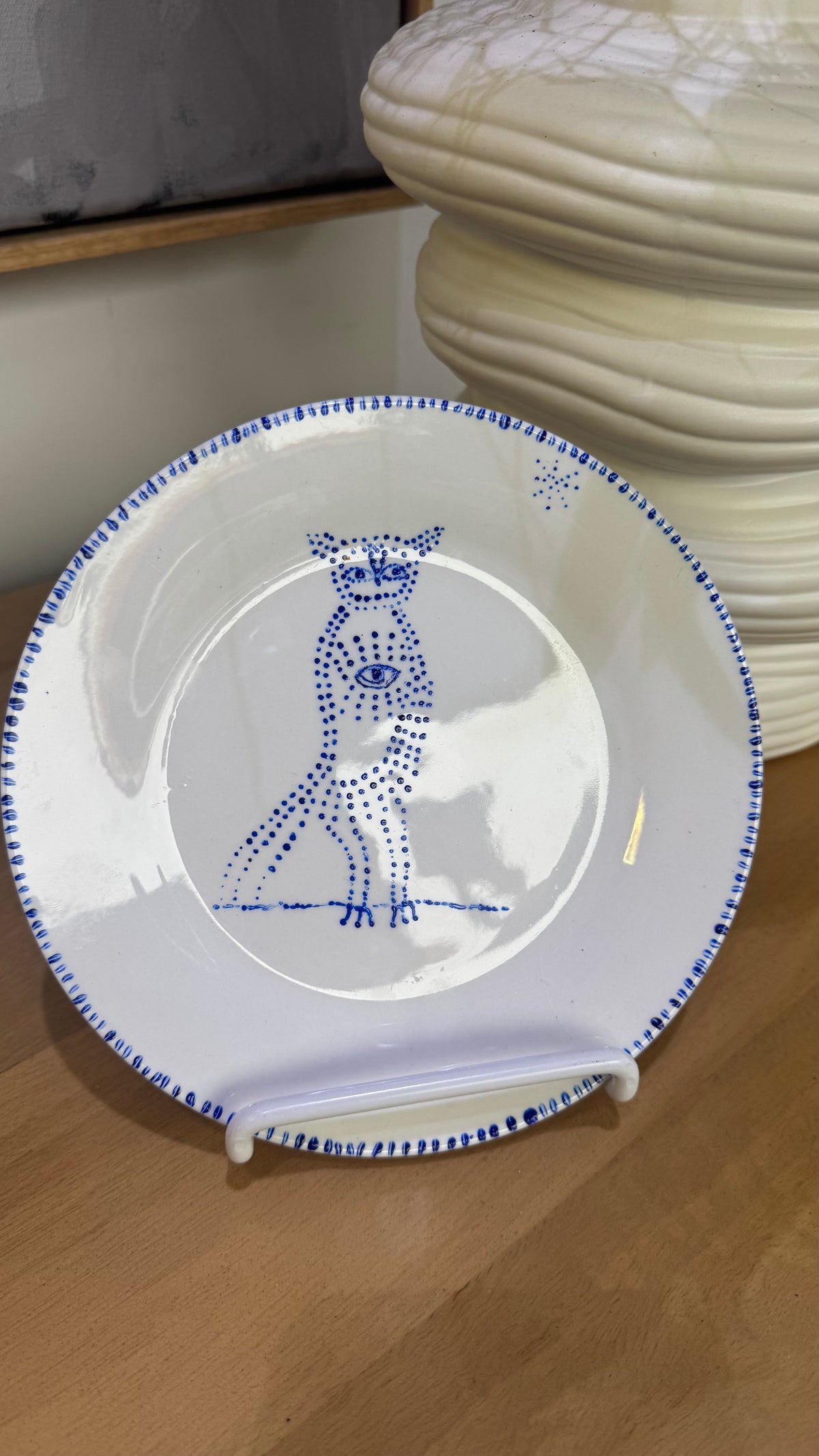ceramic wall plate featuring blue cosmic owl by artist Nadia Robertson