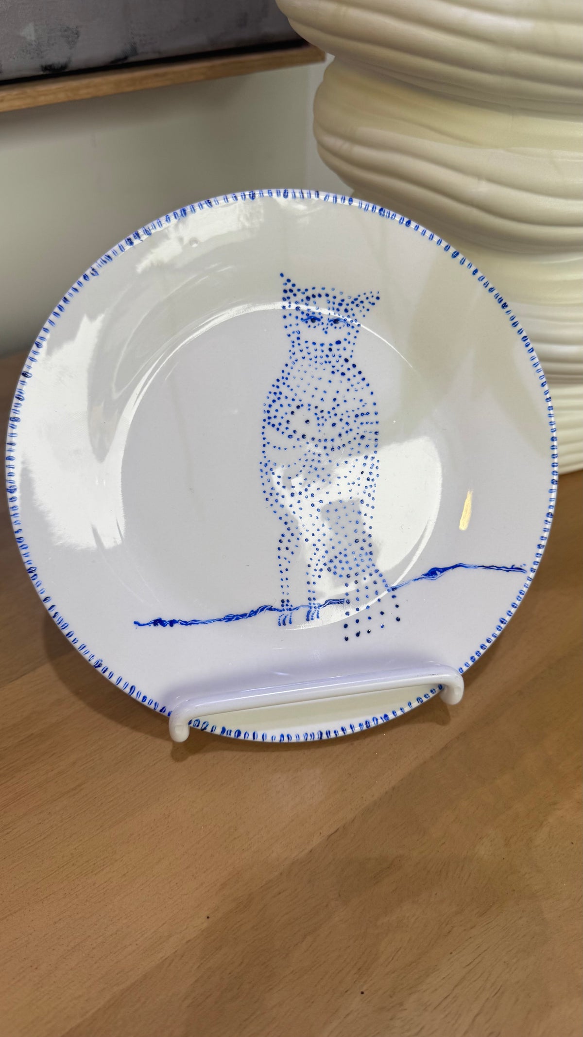 ceramic wall plate featuring blue cosmic owl by artist Nadia Robertson