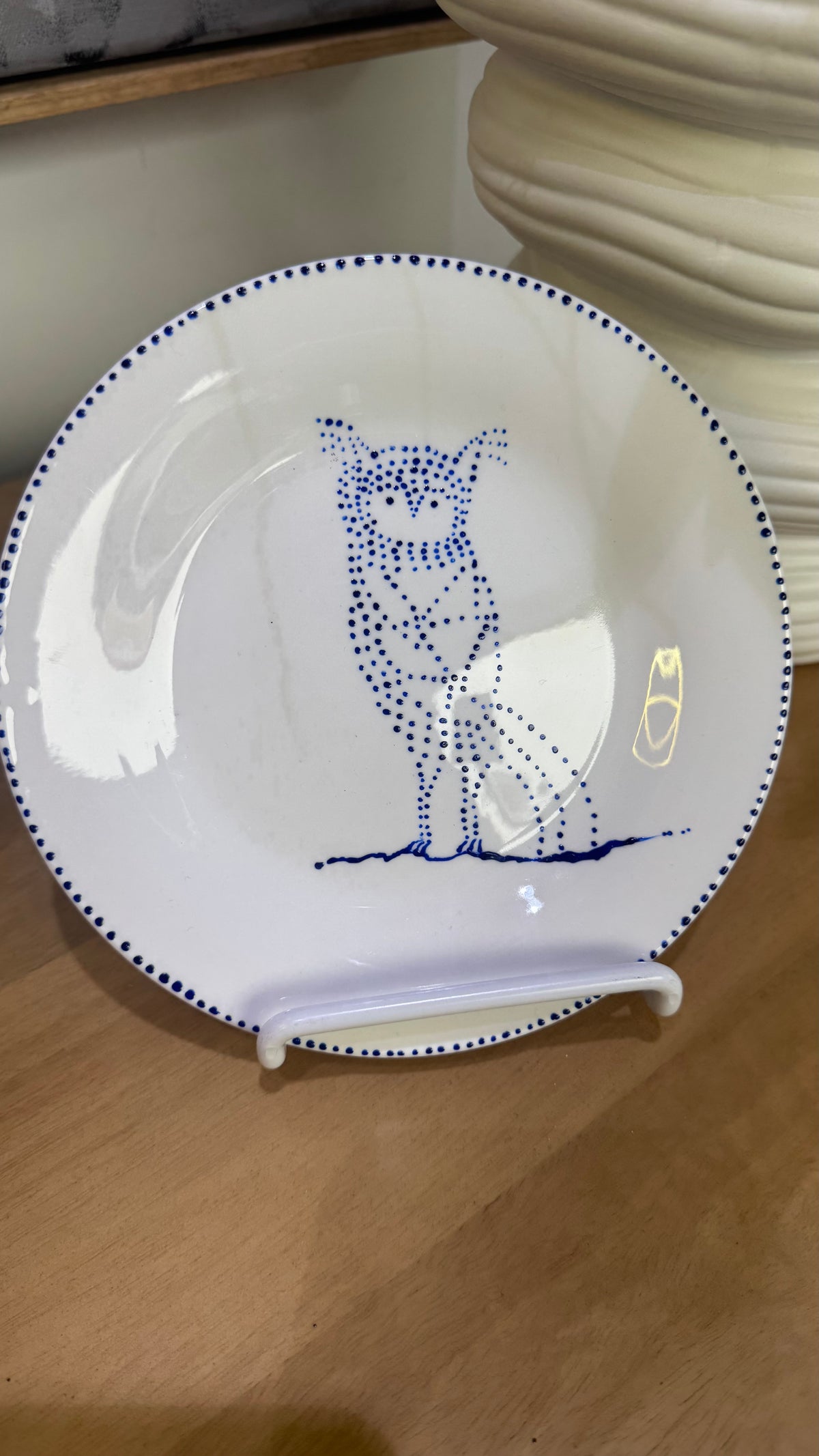 ceramic wall plate featuring blue cosmic owl by artist Nadia Robertson
