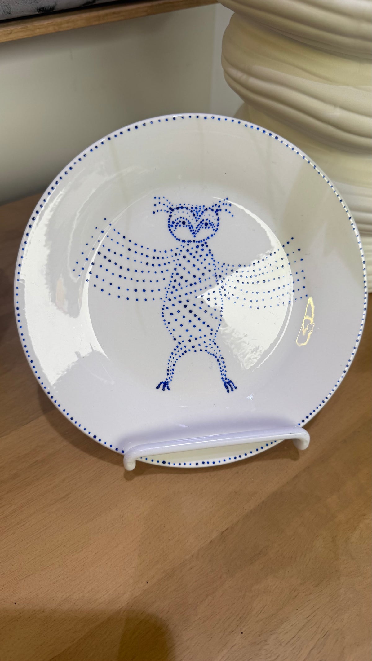 ceramic wall plate featuring blue cosmic owl by artist Nadia Robertson