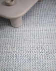 Textured blue rug with arrow  pattern