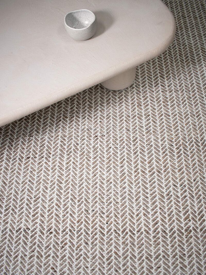 Textured neutral rug with a herringbone pattern 
