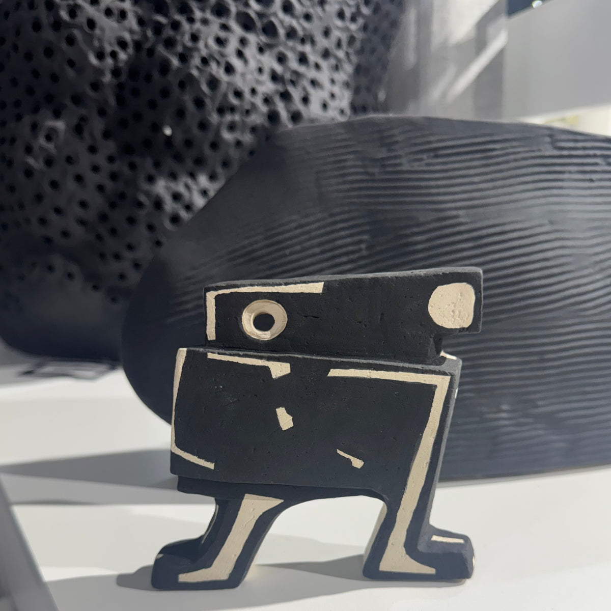 black and white ceramic sculpture with geometric pattern
