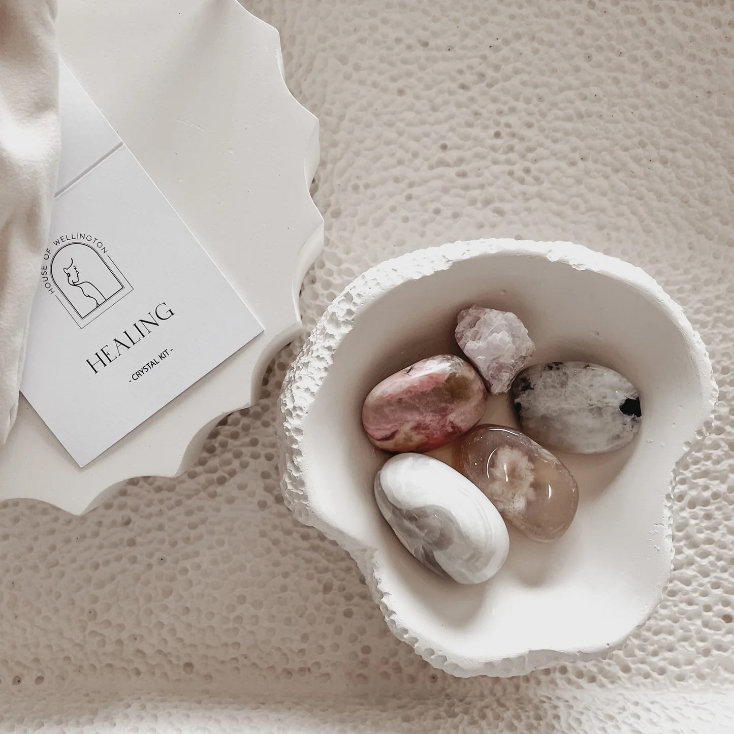 Crystal healing kit in a white draw string pouch
