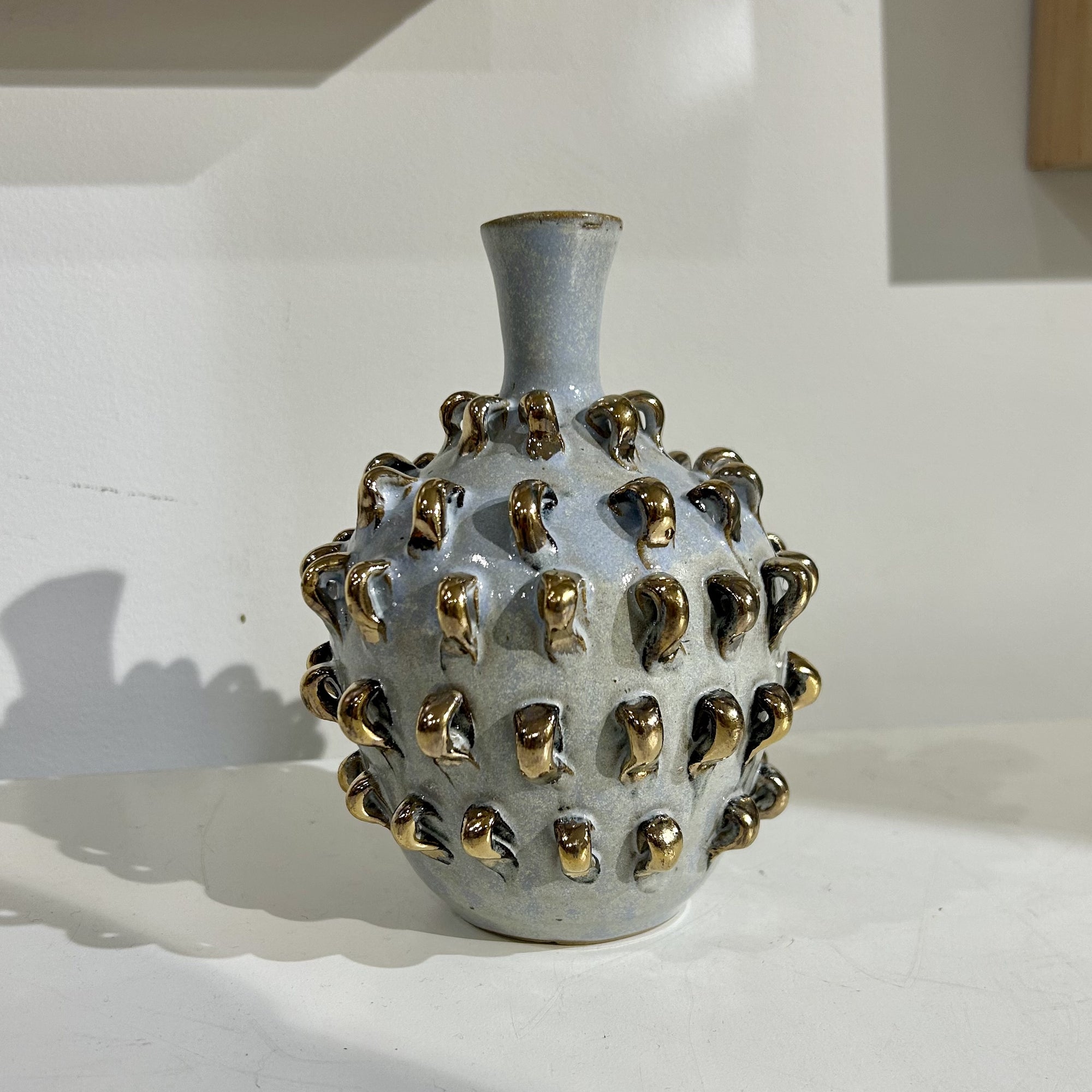 Embroider vase by ceramic artist Juyeon. Blue glaze with gold textured details.