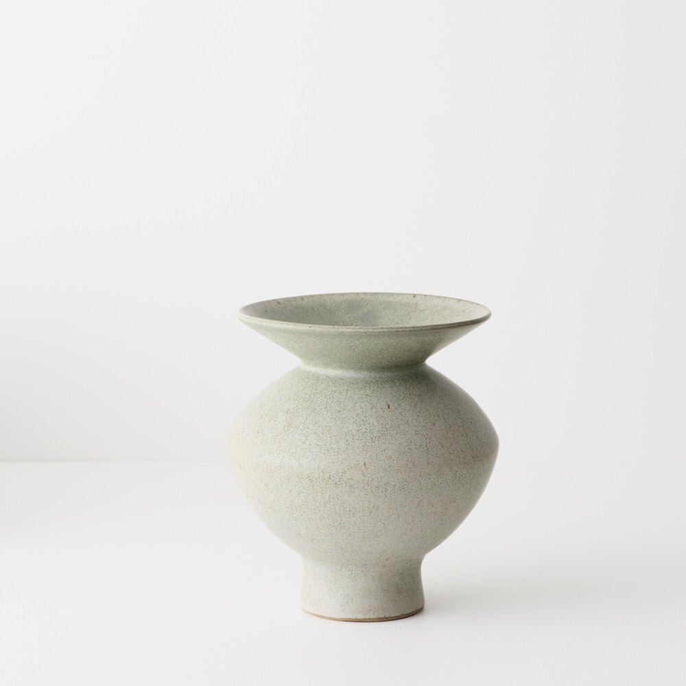 Light green ceramic vase with a flared rim and tapered bottom.