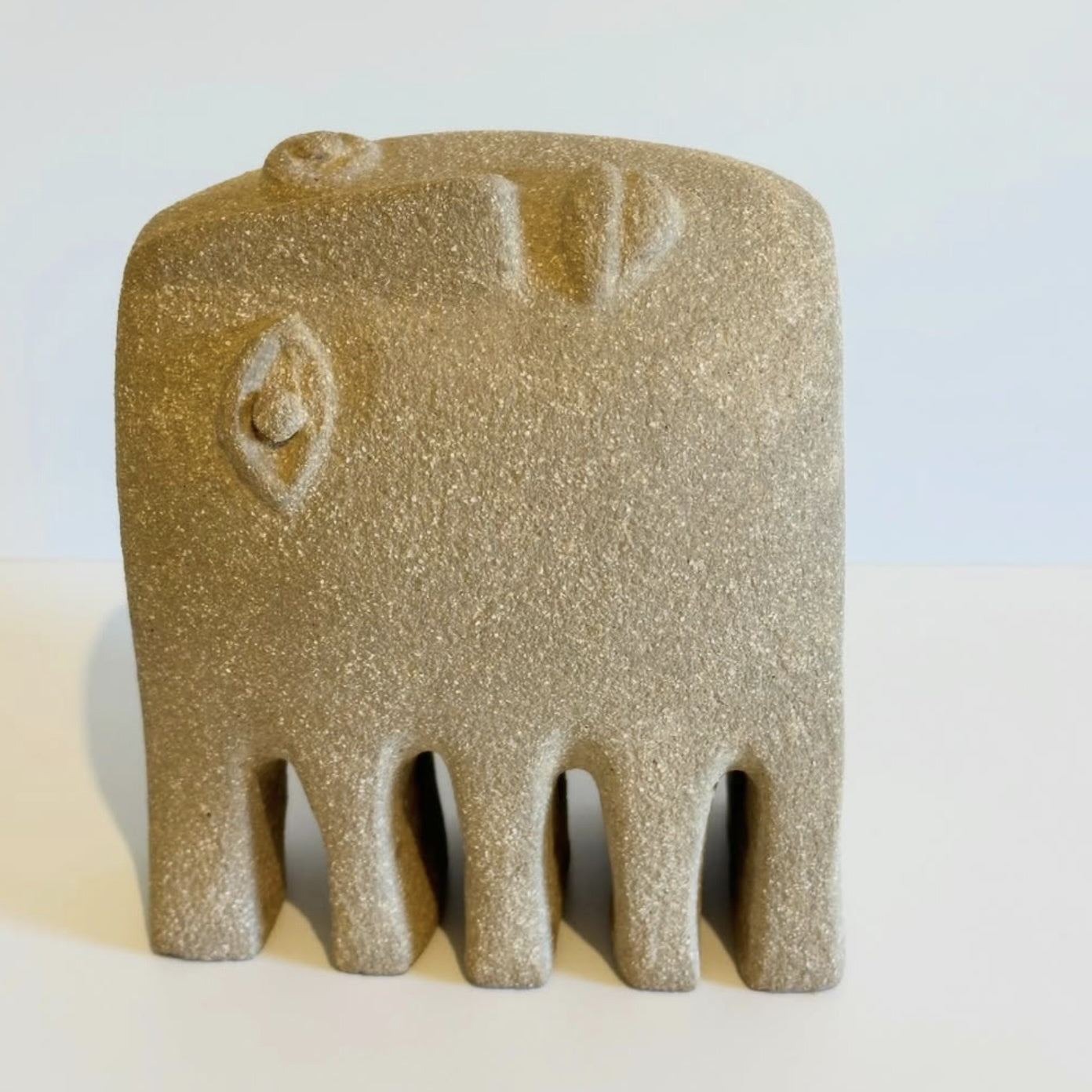 Textured beige ceramic fish sculpture 