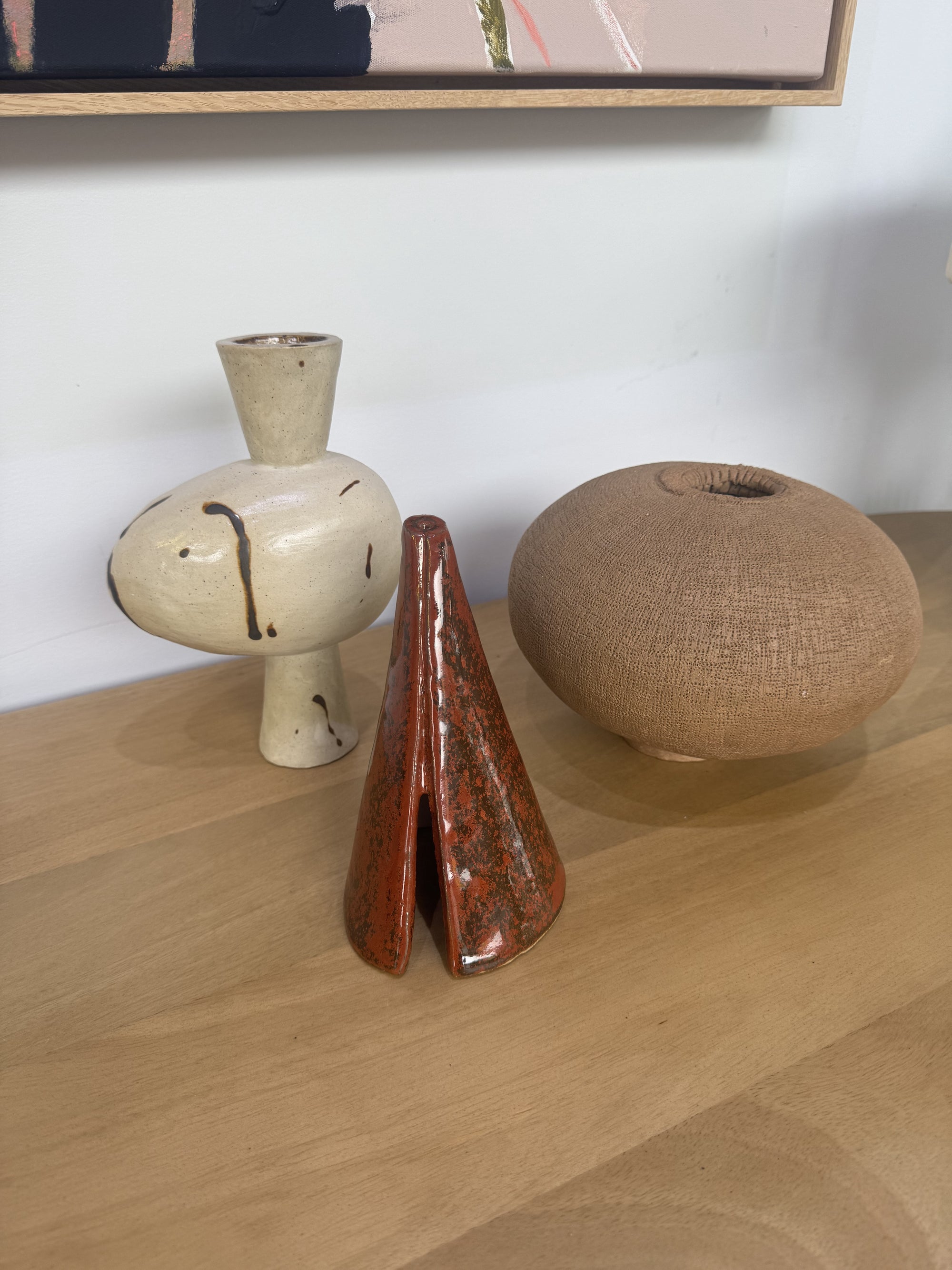 ceramic glazed sculptural cone in a rich rust tone.