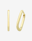 Gold hoop earrings on a light gray background