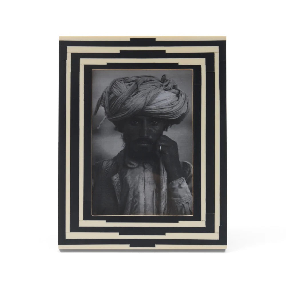 Framed black and white portrait  featuring a geometric art deco pattern